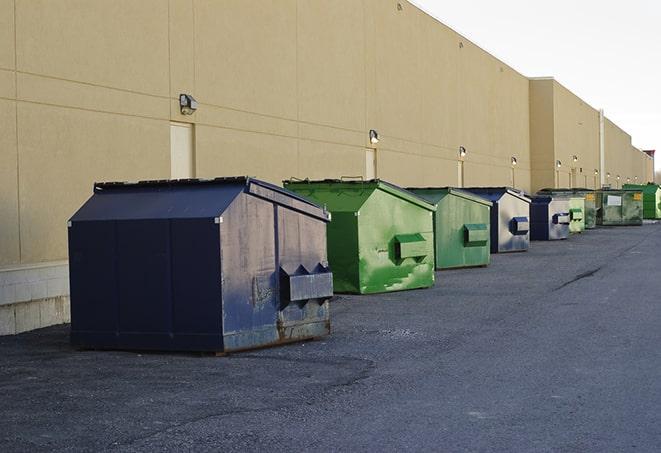 a row of large construction dumpsters on-site in Blue Jay